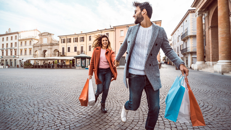 Happy shoppers running