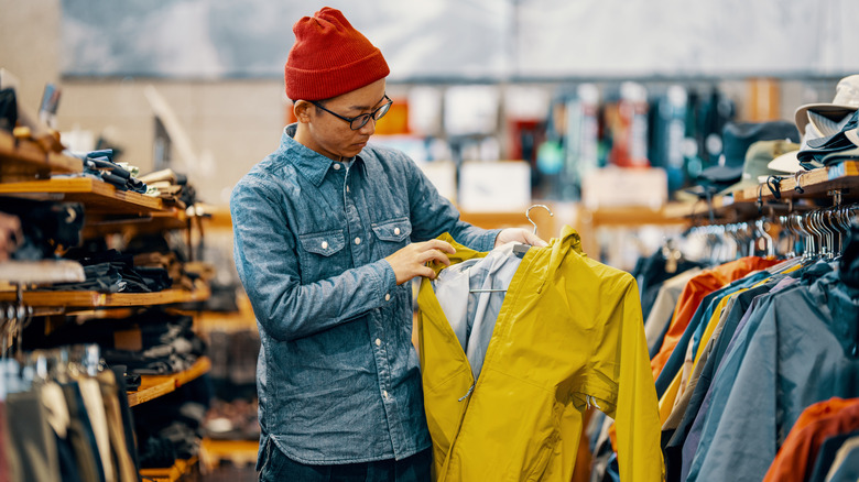 Man looking at jacket in clothing store