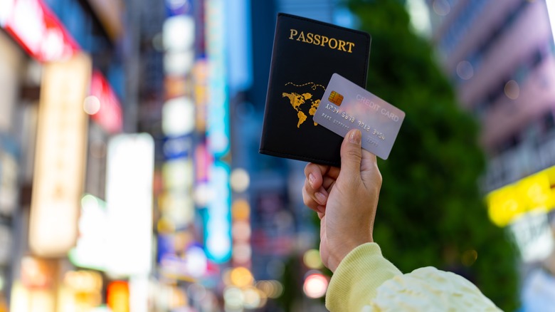 Woman holding passport and credit card