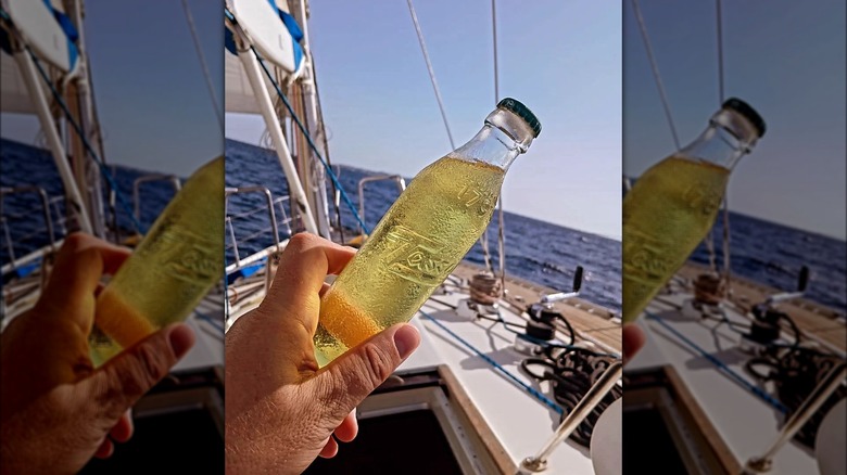 Bottle of Cedrata against sailboat