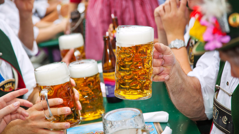 woman carrying large beer steins