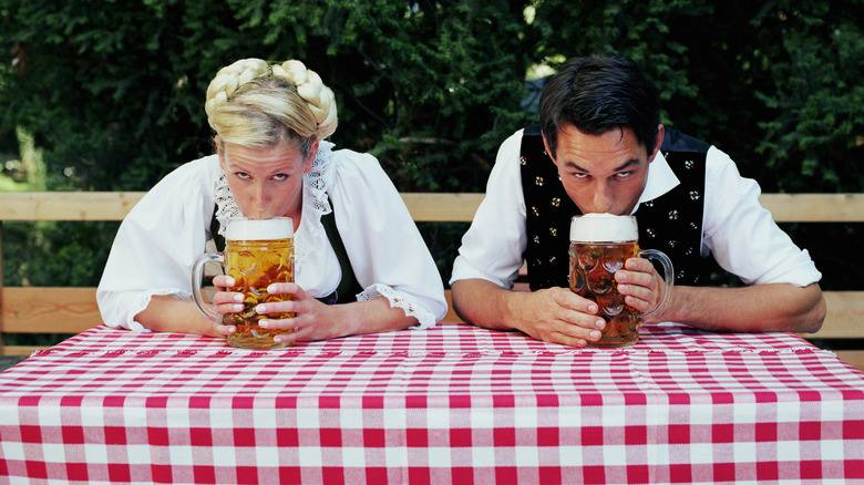 traditionally dressed people drinking beer