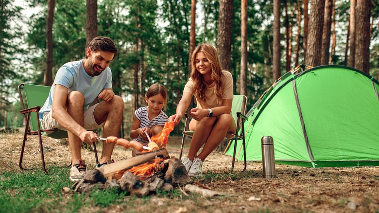 Family sitting by campfire