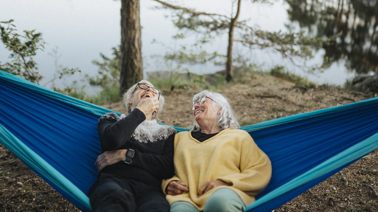 people laughing on a hammock