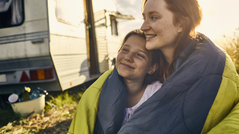 Family cuddled in sleeping bag