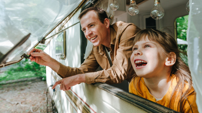 Family looking out RV window