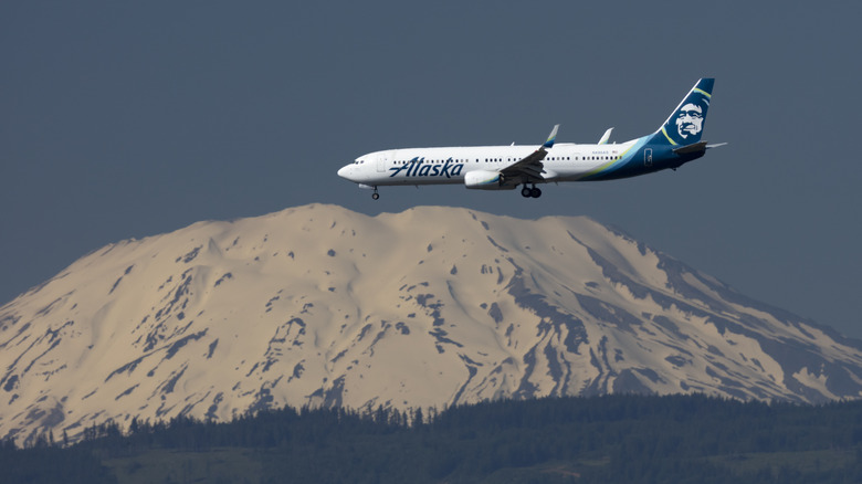 Alaska airplane flies over mountain