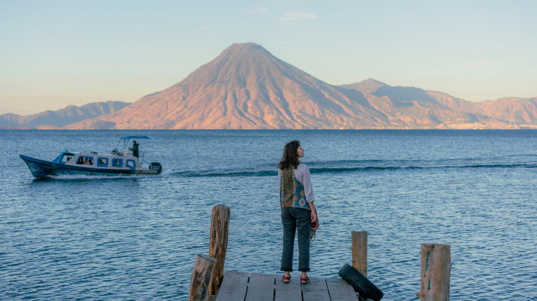 Traveler standing on pier at Lake Atitlan