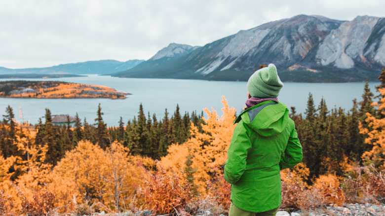 woman looking at water and mountain view