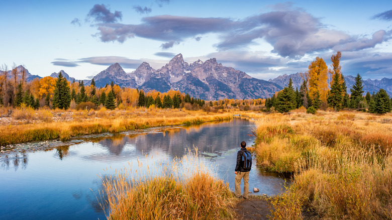 guy at lake looking at mountain