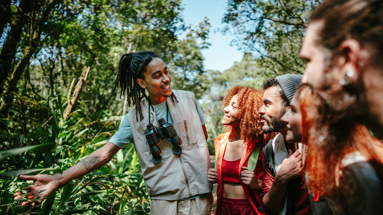 A guide shows a small group some local fauna