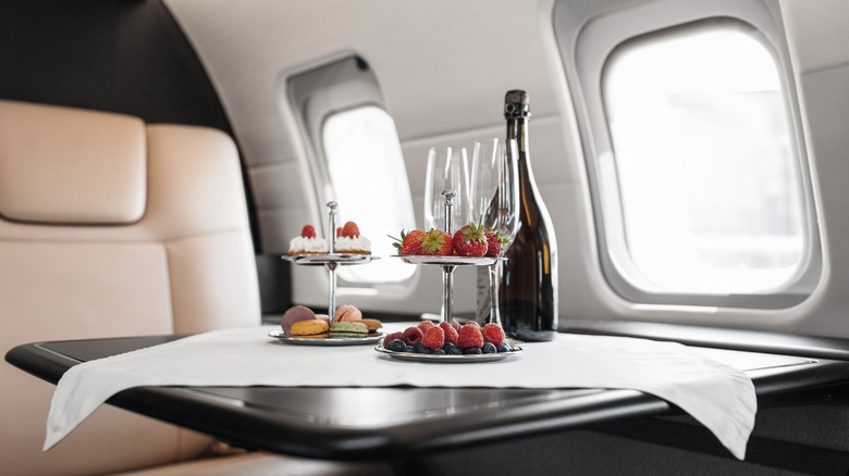 fruit and desert trays in front of airplane seat