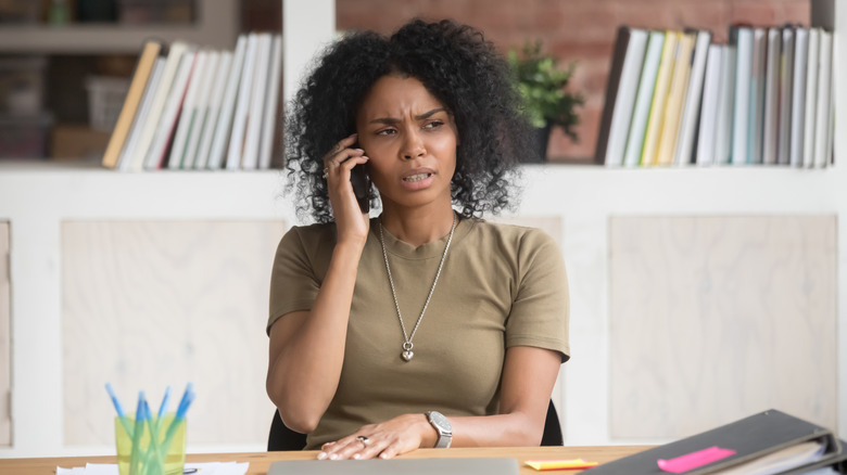 woman on phone looking annoyed