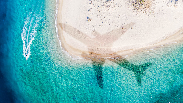 Airplane flying over beach