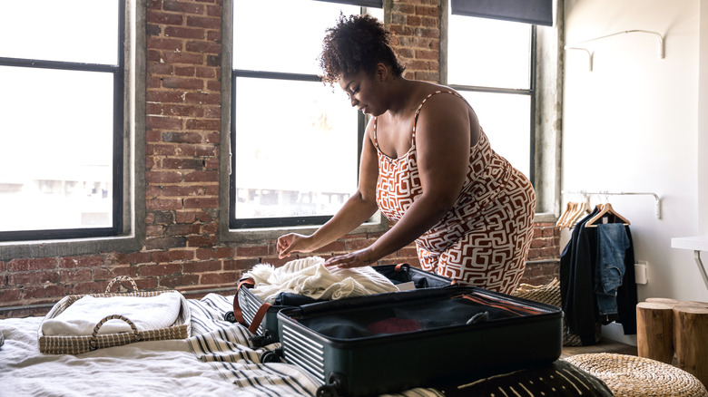 woman packing suitcase