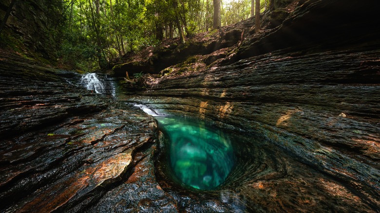 Aquamarine waters of the Devil's Bathtub in Jefferson National Forest, Virginia