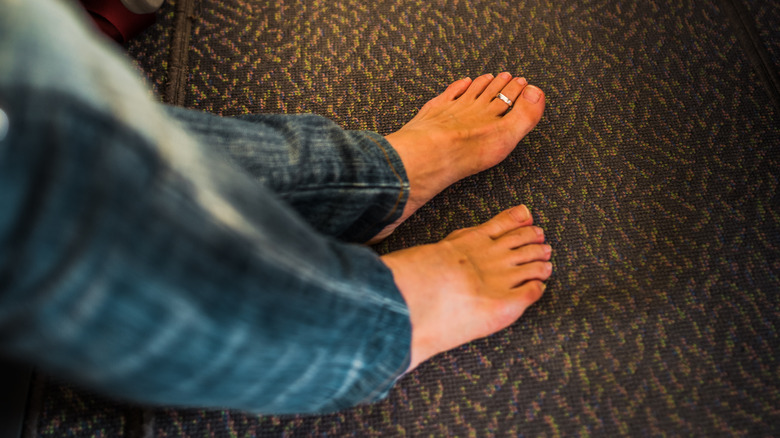Bare feet on airplane floor