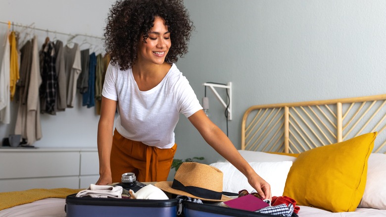 smiling woman with open suitcase