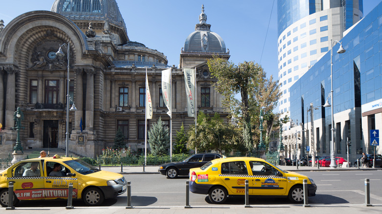 Taxis lined up outside buildings in Bucharest, Romania