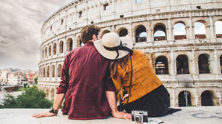 A couple looking at the Colosseum in Rome