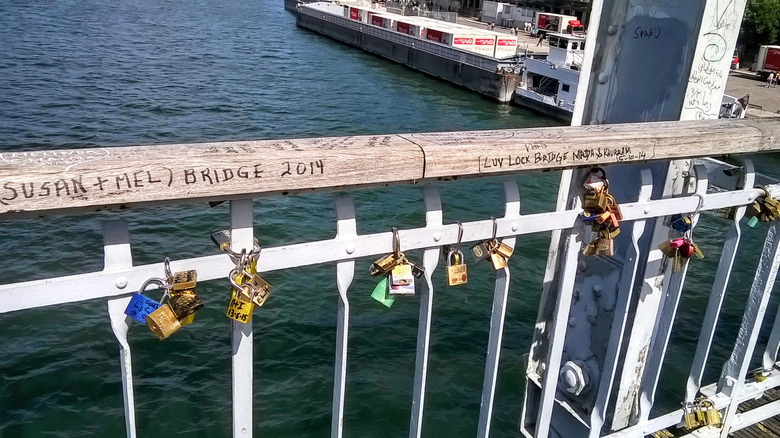 Padlocks on a bridge over water