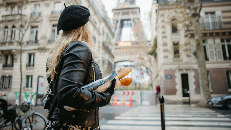 Woman holding baguettes in Paris