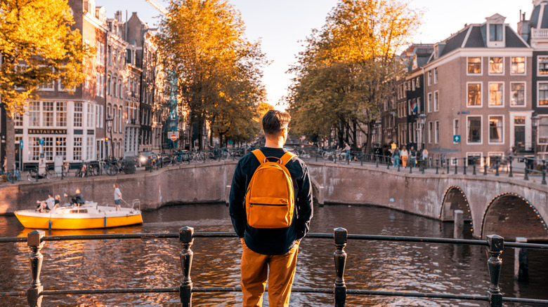 tourist looking at Amsterdam canal