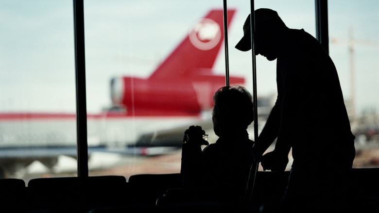 Silhouette of wheelchair traveler at the airport