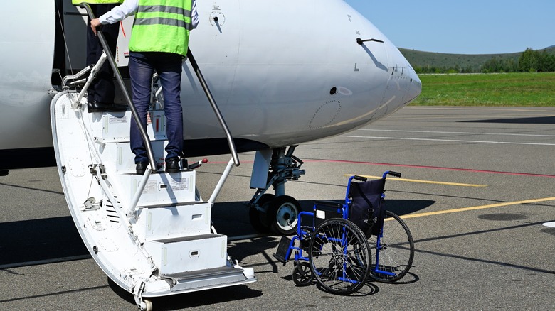 Empty wheelchair sitting near plane