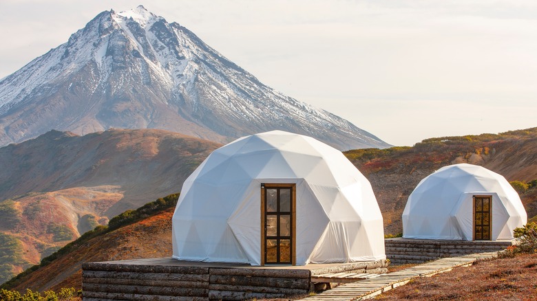 Eco-dome in front snowy mountain