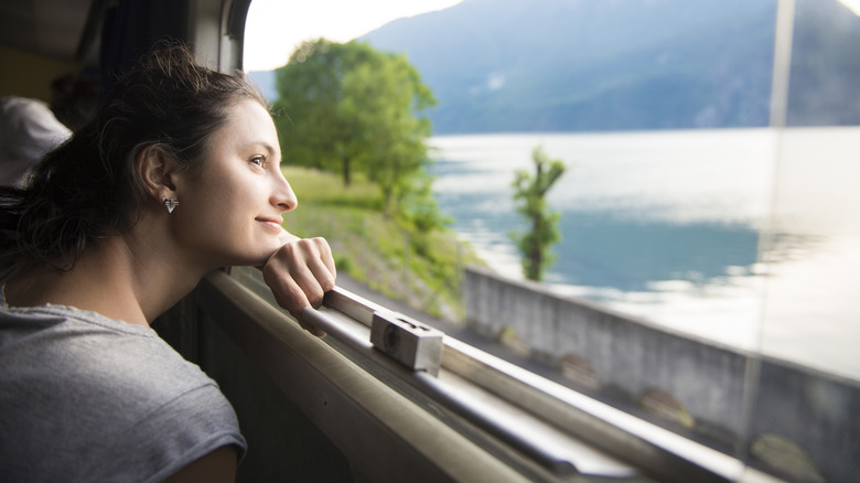 Woman gazing out train window