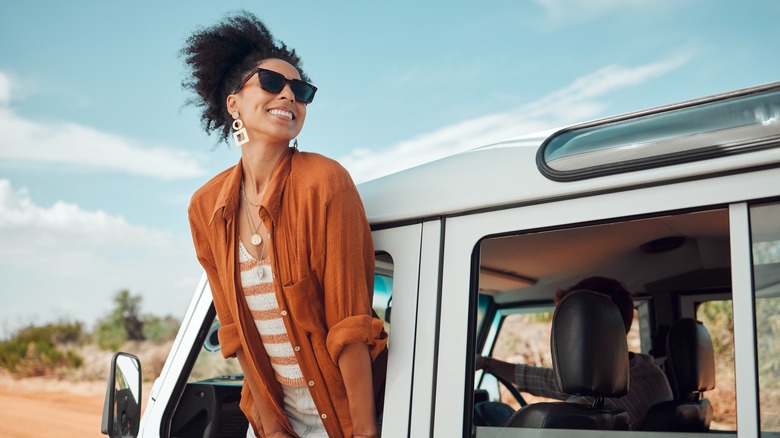 Person leaning out a car window