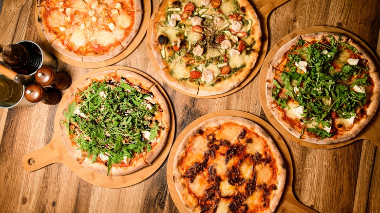 Table with assortment of pizzas