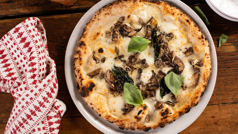 White pizza with mushrooms and basil