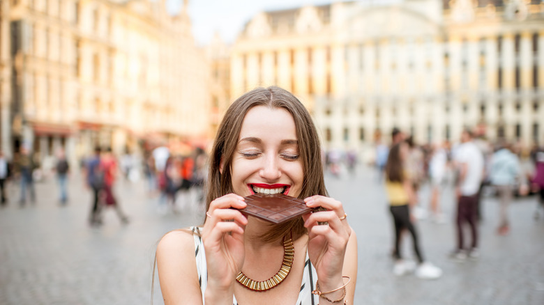 Woman eating chocolate in Brussels