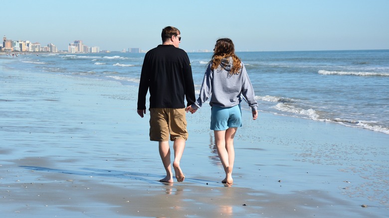 Couple walking on Myrtle Beach during the off-season