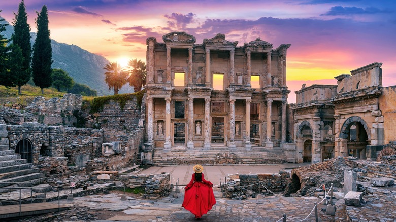 woman in front of ruins