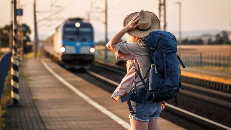 Backpacker standing at train station