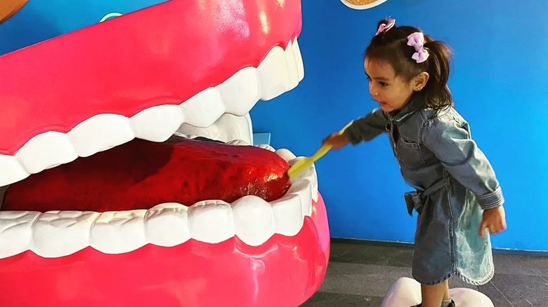 Child brushing oversized teeth