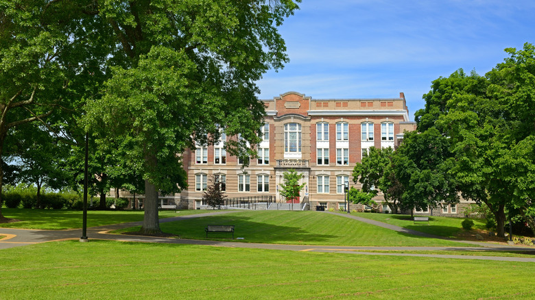 brick building among lawns and trees