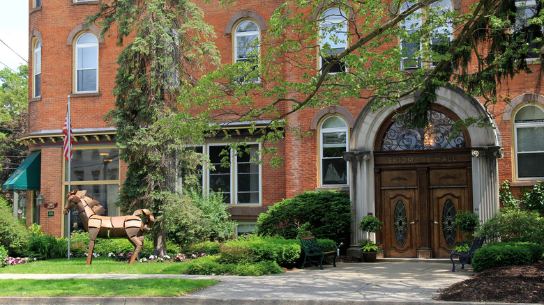 brick building with trees in front