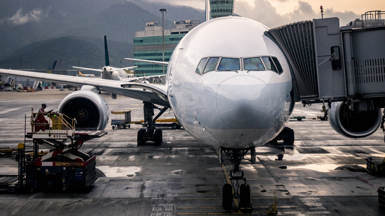 Aircraft parked at airport at sunset