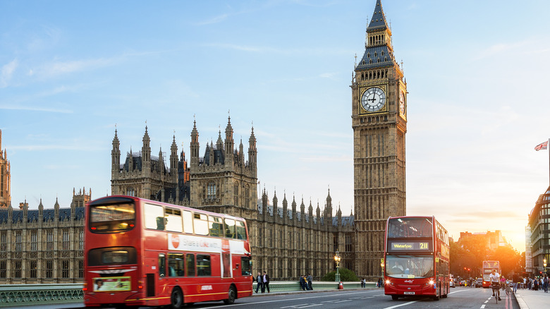 iconic two tiered red buses with Big Ben in the background