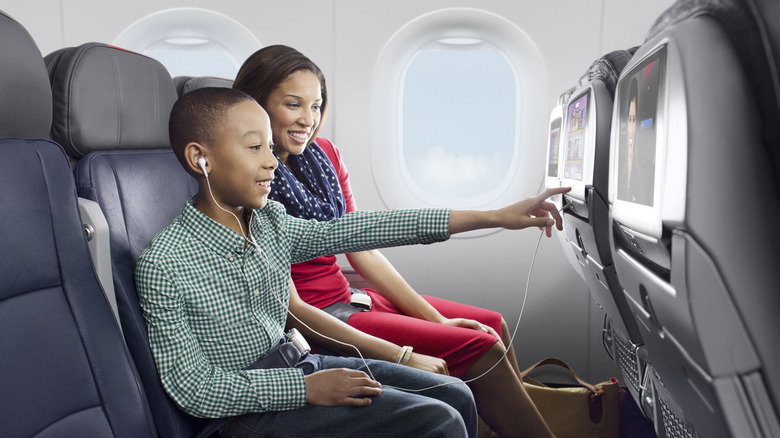 A kid enjoying seat screen