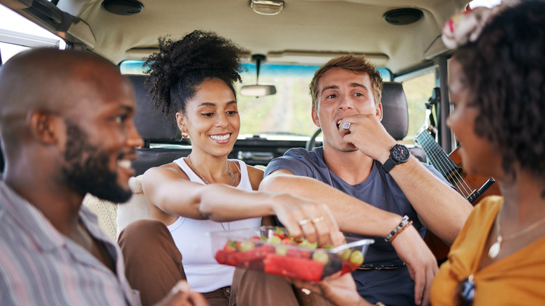 Friends eating fruits in car