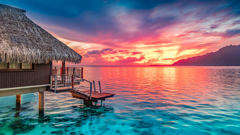 Overwater bungalow at sunset