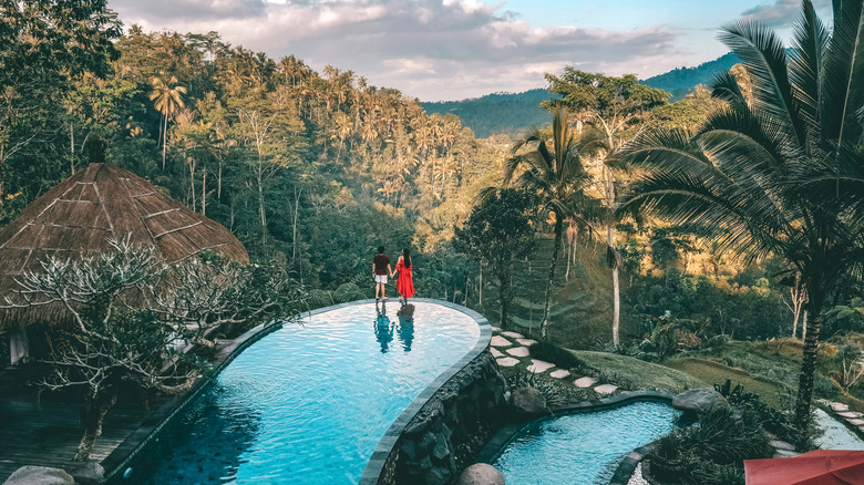 couple standing by pool in bali