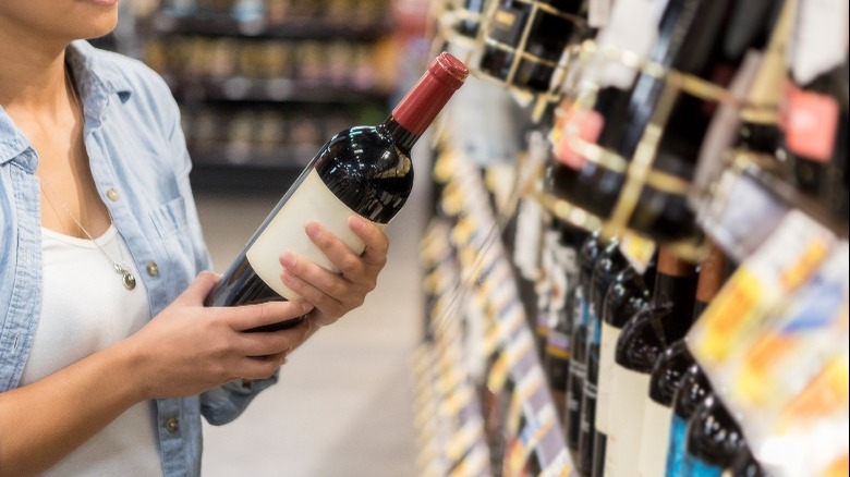 choosing wine in grocery store