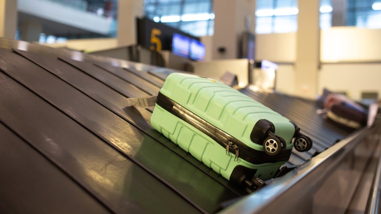 suitcase on baggage claim carousel