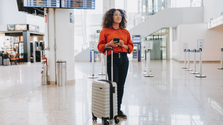 woman at airport with suitcase